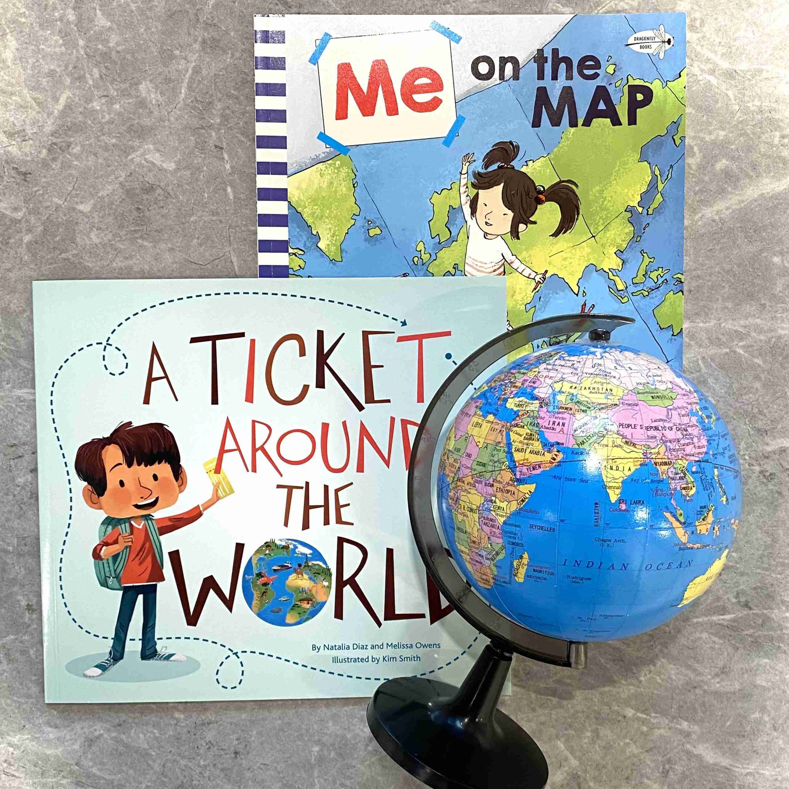 World globe and 2 books on the topic of around the world