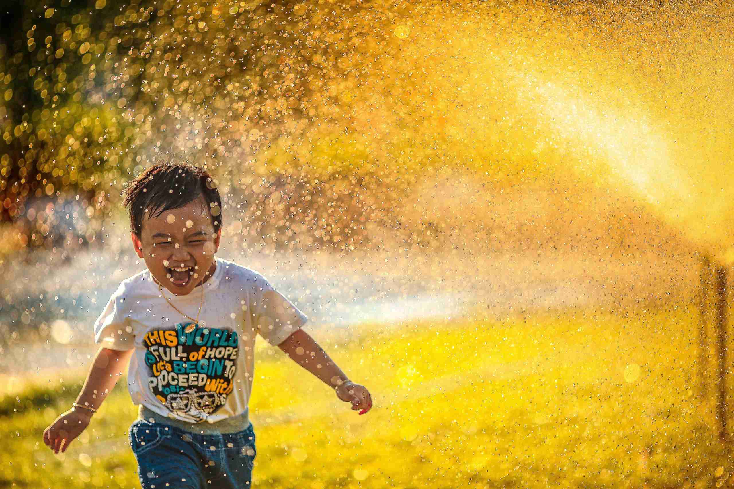 A child running through splashes of water