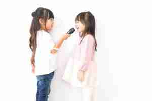Two Girls Holding A Microphone