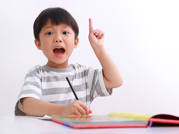 Boy Holding A Pencil and Pointing