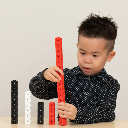 Boy playing with maths manipulatives