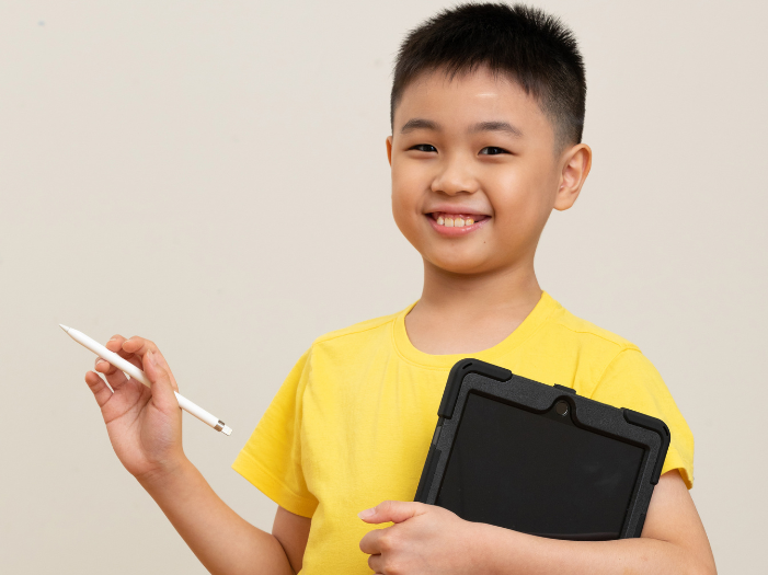 Boy holding an iPad and Pen