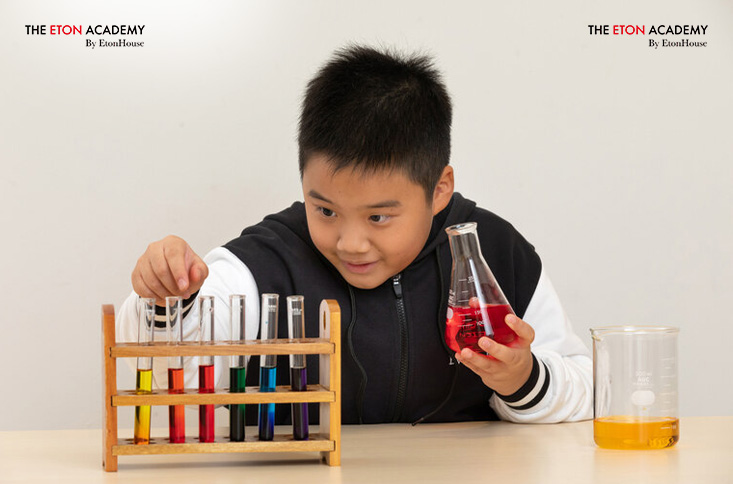 Primary school boy doing a science experiment.