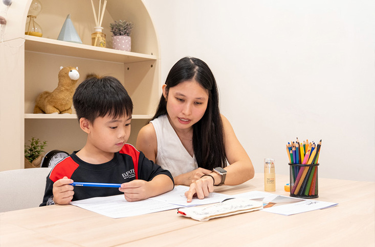 The Eton Academy teacher helping student with homework.
